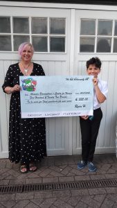 Joy from Anawim and Ryan from We Can holding a large cheque for 522 pounds. 